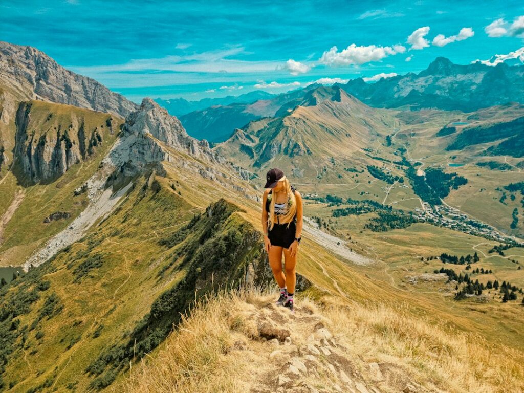 Athletic woman on a mountain trail. Photo by Godefroy Boutet on Unsplash.