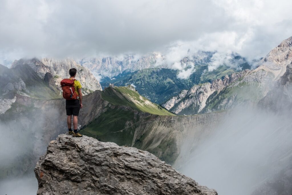 Fit hiker overlooking a mountain landscape. Photo by Lucas Clara on Unsplash.